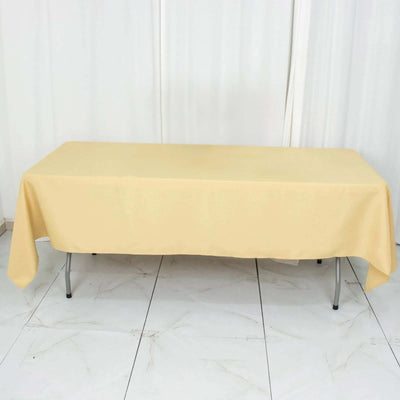 Beige tablecloth draped over a folding table in a studio setting