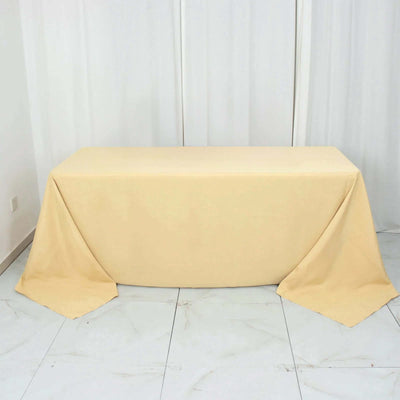 Beige tablecloth draped over a table in a studio setting.