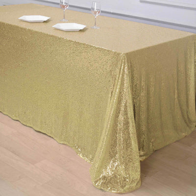 Gold sequin tablecloth draped elegantly over a table.
