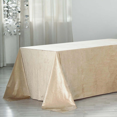 Elegant beige tablecloth draped on a table in a softly lit setting.