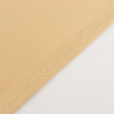 Close-up of soft beige fabric with detailed stitching.