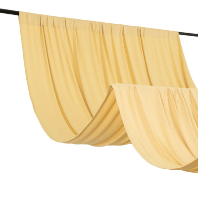 Yellow drapery fabric hanging on a rod in soft folds