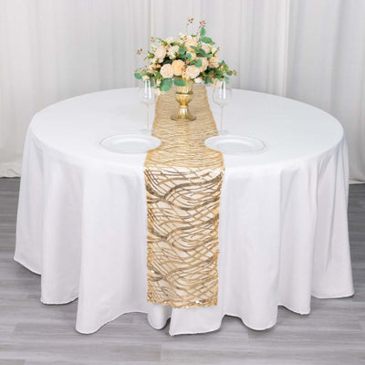 Elegant gold table runner with floral centerpiece on a round table.
