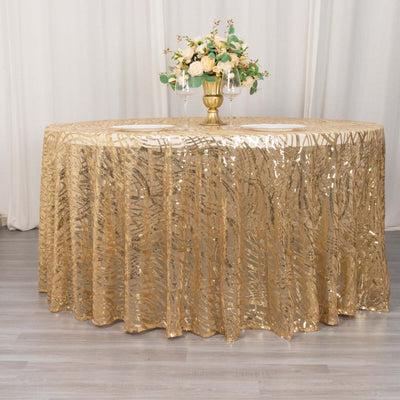Gold sequin tablecloth draped elegantly on a round table with floral centerpiece.