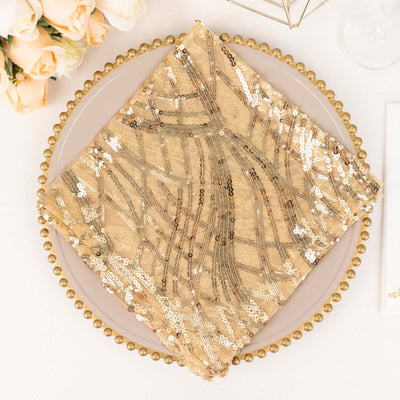 Gold sequined napkin on a decorative plate with a floral backdrop.
