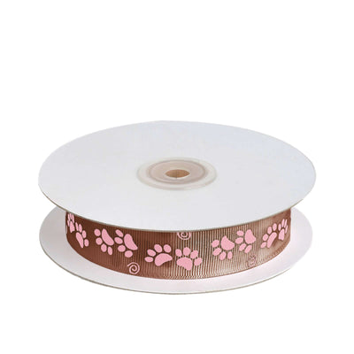 Brown ribbon with pink paw print design on a spool.