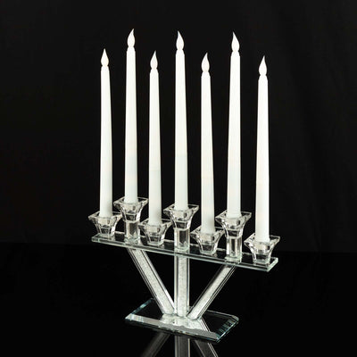 Crystal menorah with eight white candles on a sleek base.