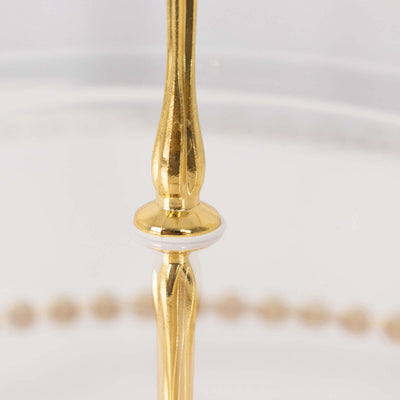 Elegant gold serving stand with detailed craftsmanship.