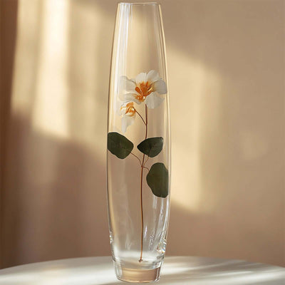 Elegant glass vase with a floral design and green leaves.