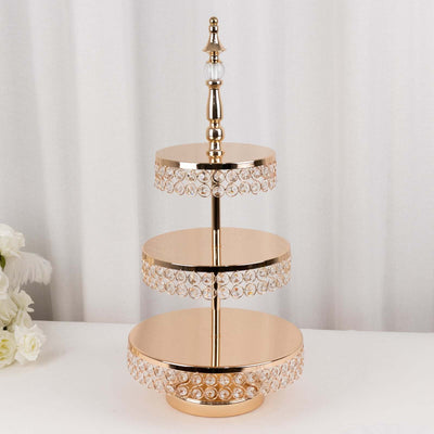 Elegant three-tiered gold dessert stand with crystal accents for celebrations.