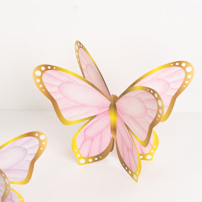 Colorful butterfly decoration with pink and yellow details.