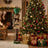 Festive Christmas living room with decorated tree, gifts, and nutcracker bear