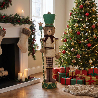Festive Christmas living room with decorated tree, gifts, and teddy bear nutcracker