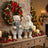 Christmas teddy bear figurines with wreaths and festive holiday decor inside a home