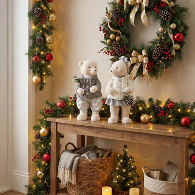 Festive Christmas wreaths with teddy bears and holiday decor on a wooden table