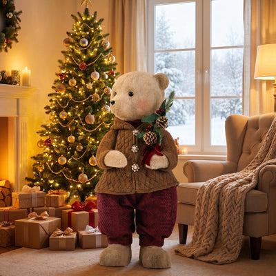 Teddy bear by Christmas tree in cozy winter living room