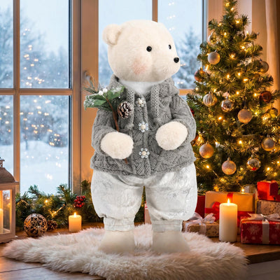 White teddy bear in Christmas sweater beside decorated tree and gifts