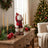 Christmas teddy bear decor on a festive table with tree and candles