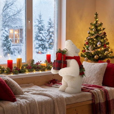 Cozy Christmas bedroom with tree, candles, teddy bear, and snowy window