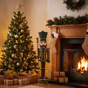 Christmas tree, nutcracker, fireplace, and wrapped gifts in a cozy holiday living room