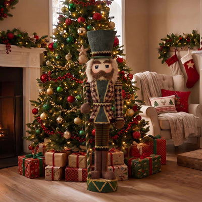 Christmas nutcracker standing in a festive living room by a decorated tree