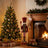 Christmas tree and fireplace decorated with stockings, nutcracker, and gift boxes