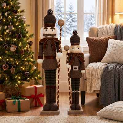 Christmas nutcracker decorations beside a lit tree in a cozy holiday living room