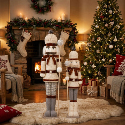 Festive Christmas living room with tree, fireplace, stockings, and nutcracker décor