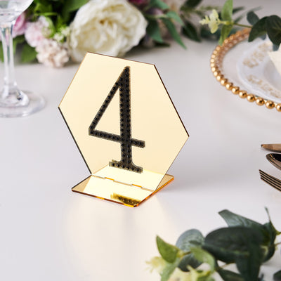 Gold mirrored table number 4 with a geometric design