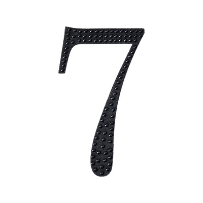 Black number 7 with textured dots on a plain white background.
