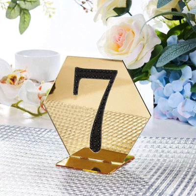 Gold hexagon table number seven stand with black detailing