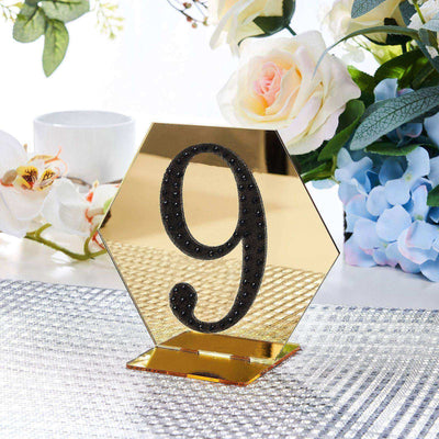 Gold hexagon table number 9 with black rhinestones in a decorative setting.