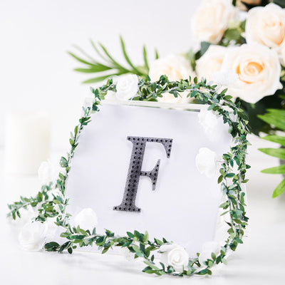 Personalized letter "F" decor with floral accents and greenery.