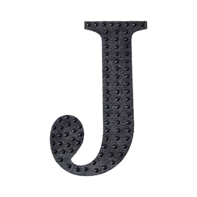 Black decorative letter "J" with studded texture on a white background.