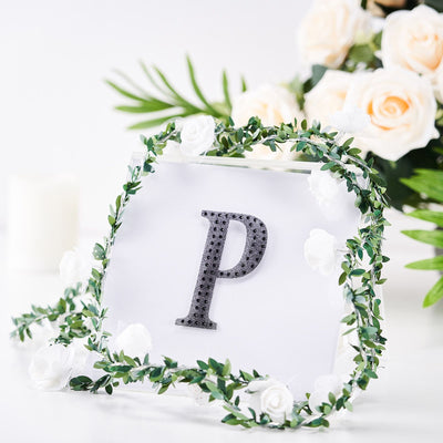 Decorative letter "P" with floral accents on a clear background.