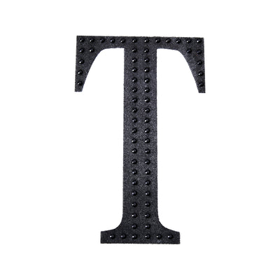Black letter "T" with studded texture on white background