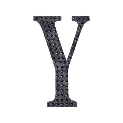 Black textured letter Y cutout on a plain white background