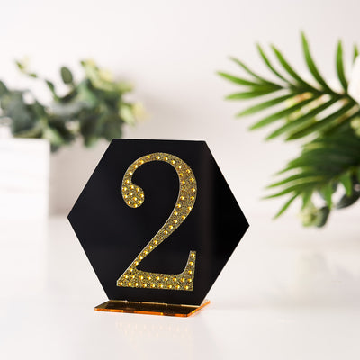 Black hexagon table number "2" with gold glitter accents.