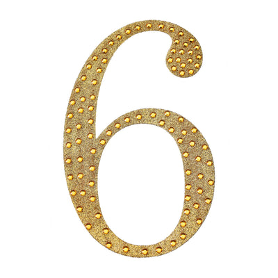 Gold marquee number six with lights on a plain background.