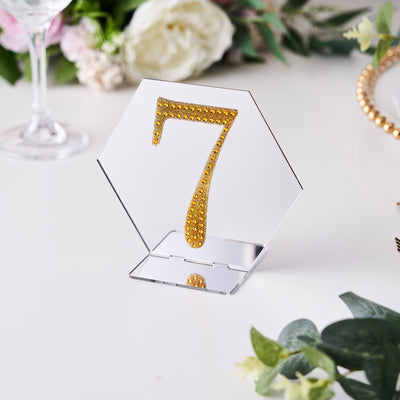 Hexagon table number 7 with golden rhinestones on a clear stand.