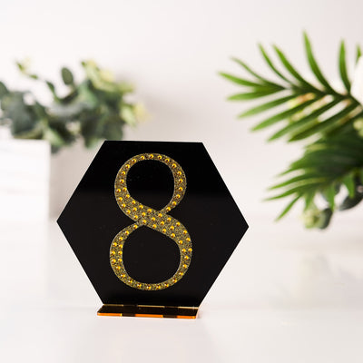 Black hexagon with gold rhinestone number 8 decoration.