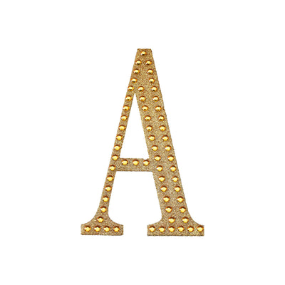 Gold marquee letter "A" with lights on a white background.