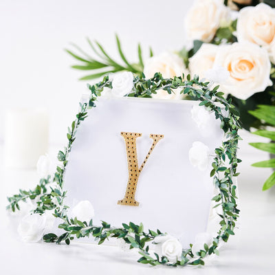Gold letter "Y" with floral decor on a clear acrylic base.