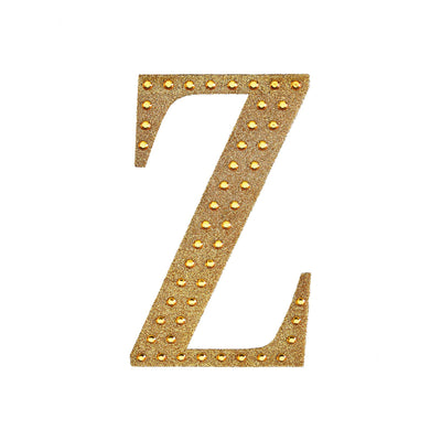 Gold studded letter Z on a white background