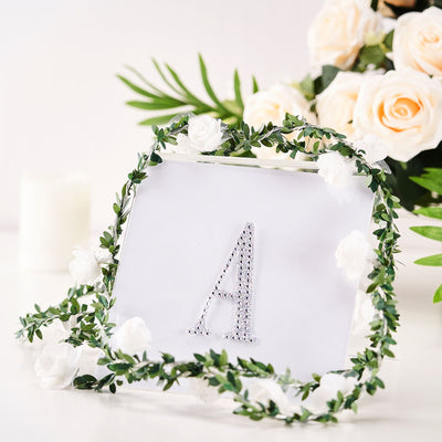 Decorative picture frame with floral accents and letter "A" design.