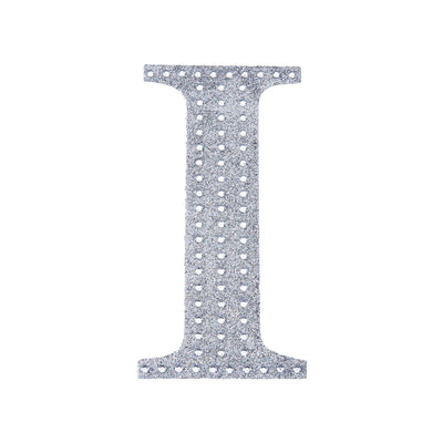 Silver letter "I" cutout on a plain background.