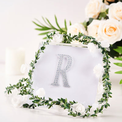 Personalized glitter letter R with floral wreath decoration.