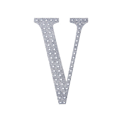 Silver rhinestone letter V on a plain background