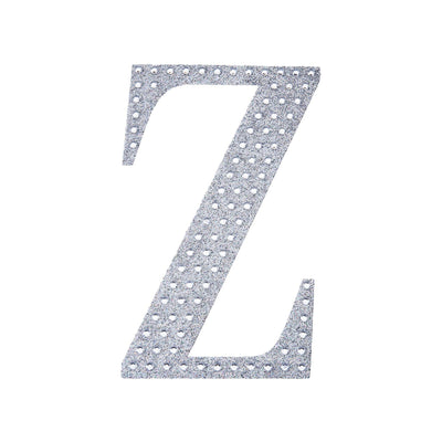Silver glitter letter "Z" cutout on white background.