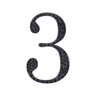 Black glitter number three on a white background